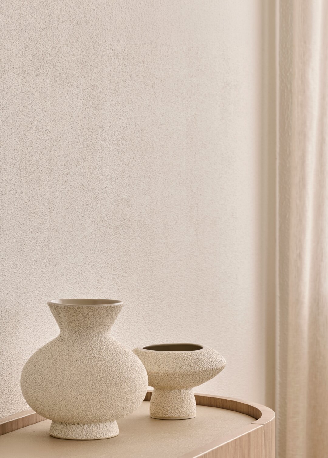Interior styling by Larritt-Evans — sculptural ceramic vases on a timber console.